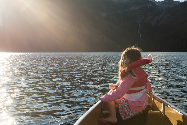 istock Child canoeing on a prisitine mountain lake 506613548