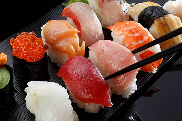 Japanese seafood sushi many tasty fresh japanese sushi with tuna, caviar and shrimp  wasabi sauce stock pictures, royalty-free photos & images