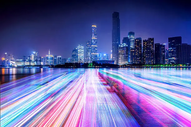 Photo of city skyline and light line on the river