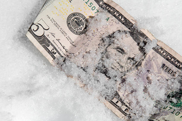 istock Five dollar bill in the snow 506615562