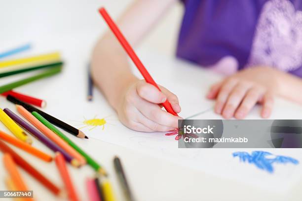 Cute Girl Drawing A Picture With Colorful Pencils Stock Photo - Download Image Now - Crayon, Drawing - Activity, Preschool Building