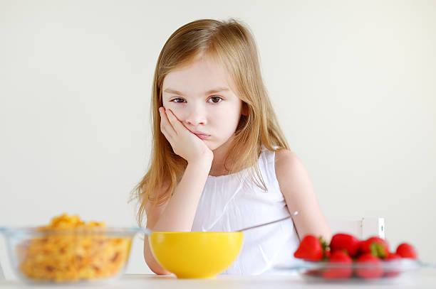 istock Little girl eating cereal with milk 506617852