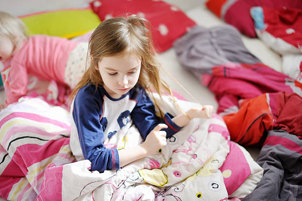 istock Two little sisters in bed on sunny morning 506618686