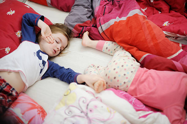 istock Two little sisters in bed on sunny morning 506618778