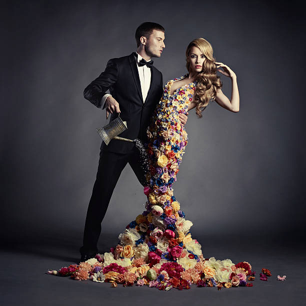 Young man and beautiful lady in flower dress stock photo