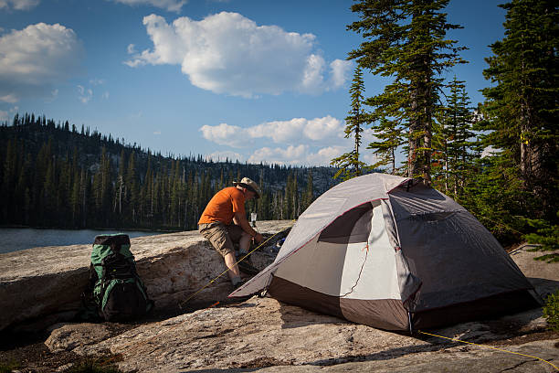istock Backpacker is starting to make dinner on his stove. 506622407
