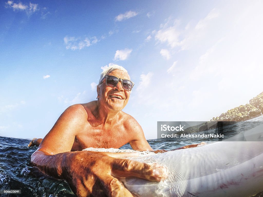 Feeling young Active and happy senior man surfing Senior Adult Stock Photo