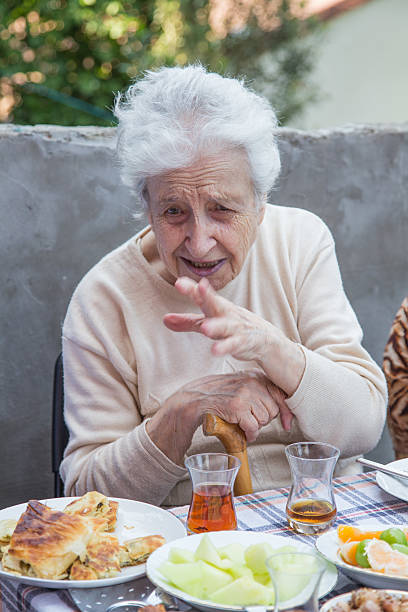 istock senior woman talking 506623707