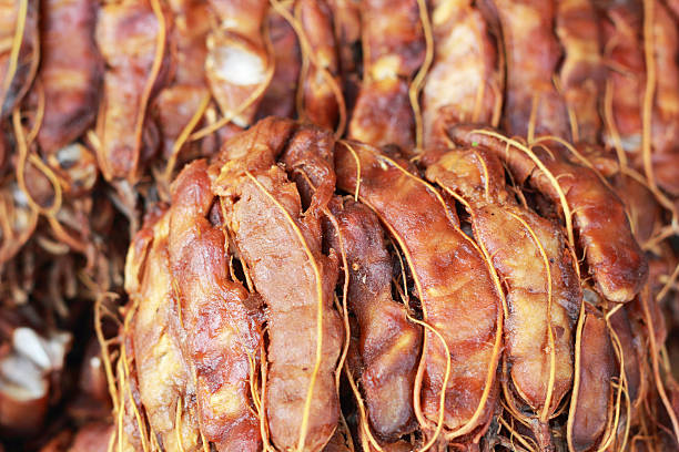 Background ripe tamarind fruit peeled.