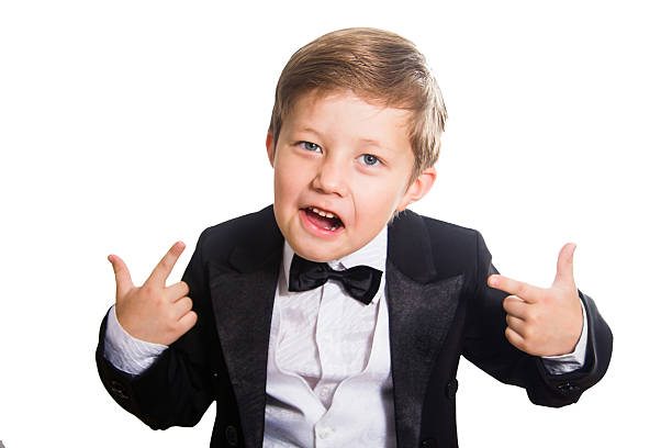 sweet laughing baby in tailcoat sitting on white ground