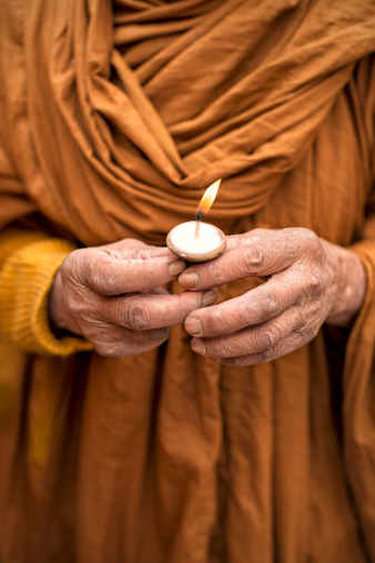 Nepalese Monk with candle in his hand.