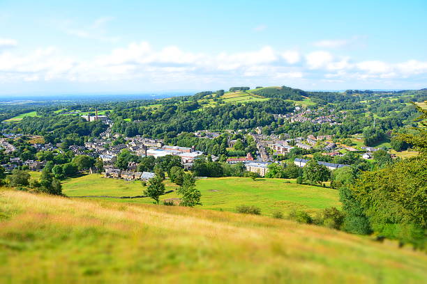 Bollington in Cheshire, England. Focus on a former cotton mill in the centre of town. A miniature effect has been used to draw attention to the centre of the image.