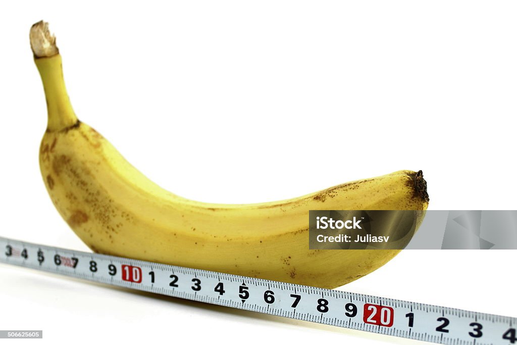 Large banana and measuring tape on white background Large banana and measuring tape on white background closeup Abstract Stock Photo