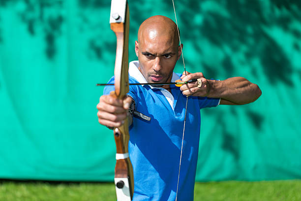istock Archer aiming at target with bow and arrow 506625809