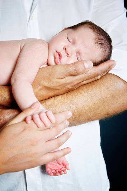 istock Father cradling his sleeping newborn son. Adorable. 506625977