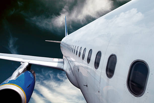 Airplane at fly on the sky with clouds