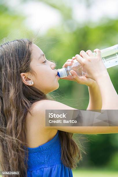 Girl Drinking A Bottle Of Water Stock Photo - Download Image Now - 10-11 Years, Blank Expression, Bottle