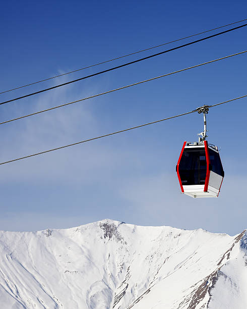 istock Gondola lift and snowy mountains 506626885