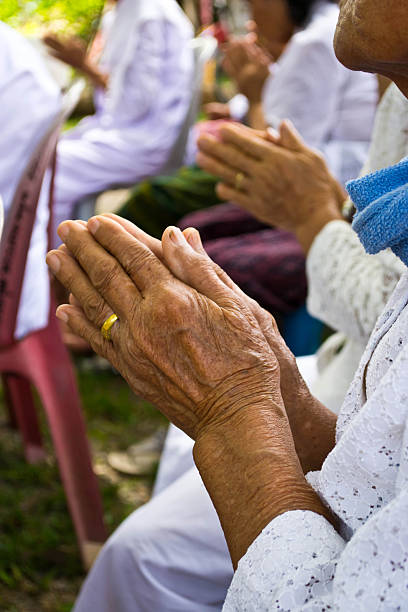istock Grandmother hands in Buddhist ritual 506650013