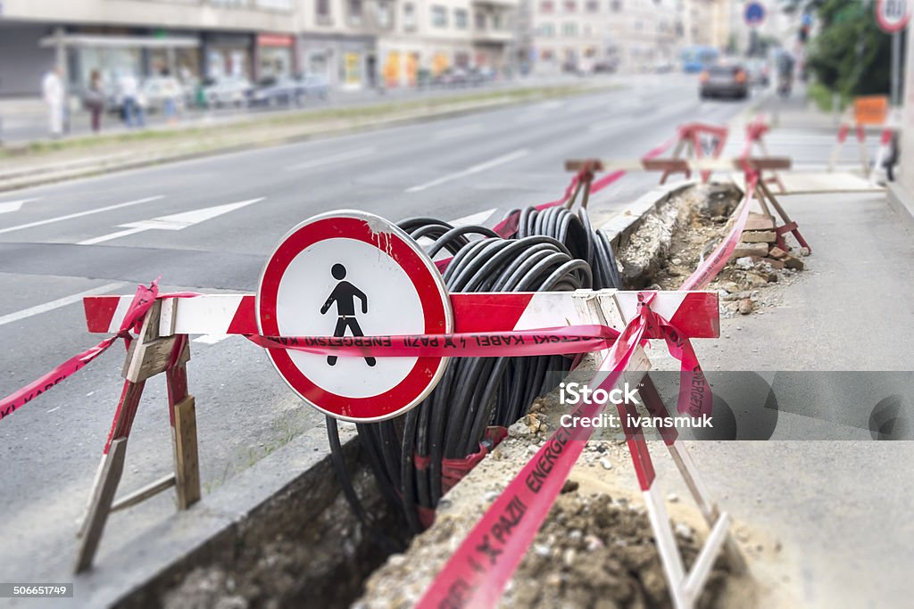 Optic and electric cable Road excavation at a construction site at conduits for the laying of fibre optic and electric cable Underground Stock Photo