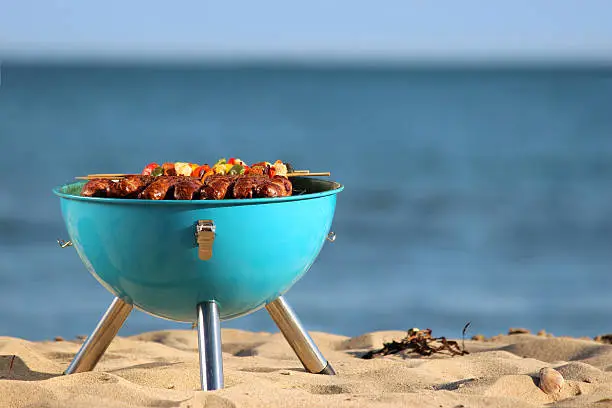 Photo of Image of beach barbecue, seaside BBQ, sausages, burgers, kebabs