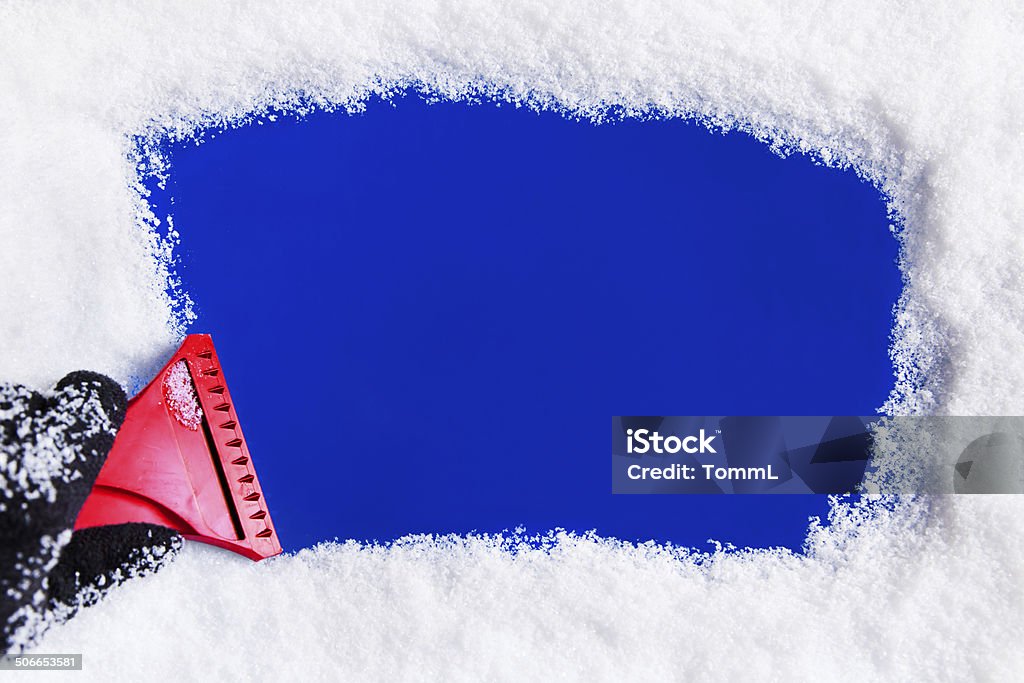 Ice Scraper on Window Hand with ice scraper removing snow or ice from a window. Ice Stock Photo