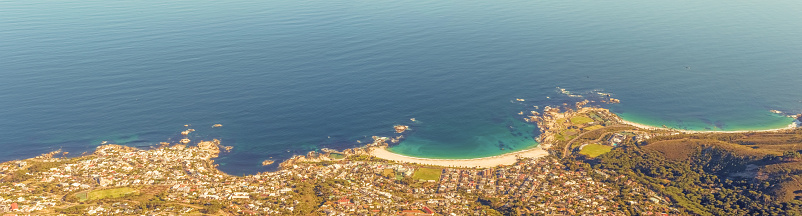 The town of Camp's Bay as viewed from Table Mountain in Cape Town, South Africa. Panorama of the coast line.