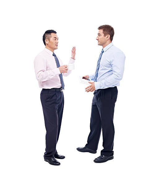 asian and caucasian businessmen talking asian and caucasian corporate executives standing and talking, isolated on white background. expatriate photos stock pictures, royalty-free photos & images