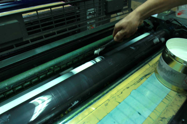 istock closeup of the ink rollers of a printing press offset machine 506663260