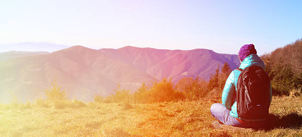 istock young woman with backpack travel in mountains 506665074