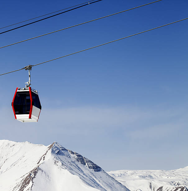 istock Gondola lift and snowy mountains 506665375
