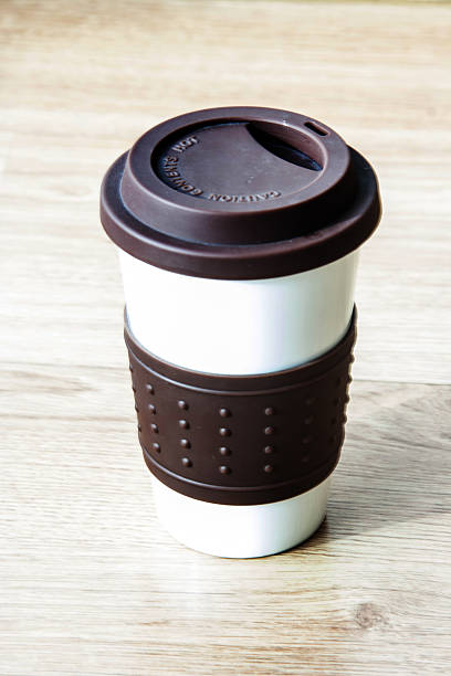 istock close up coffee cup on blurry wood table background 506666295