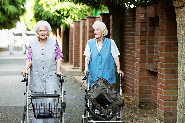 istock senior women walking supported by walker 506666481