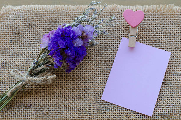 istock Bunch of Statice flowers and clip note on sackcloth background 506668770