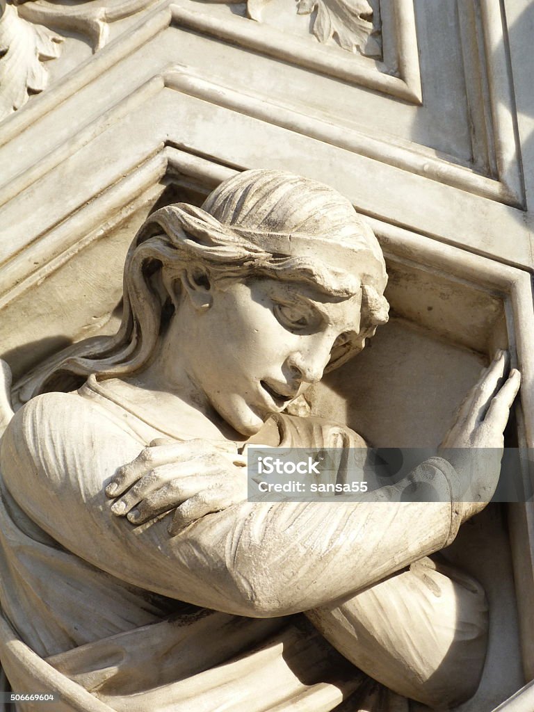 Irreverent angel on the facade of the cathedral of Florence Irreverent angel on the facade of the cathedral of Florence, Italy Angel Stock Photo