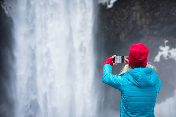 istock Woman using a smart phone to take a picture 506669876