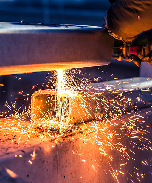 istock worker cutting steel pipe using metal torch and install roadside 506669913