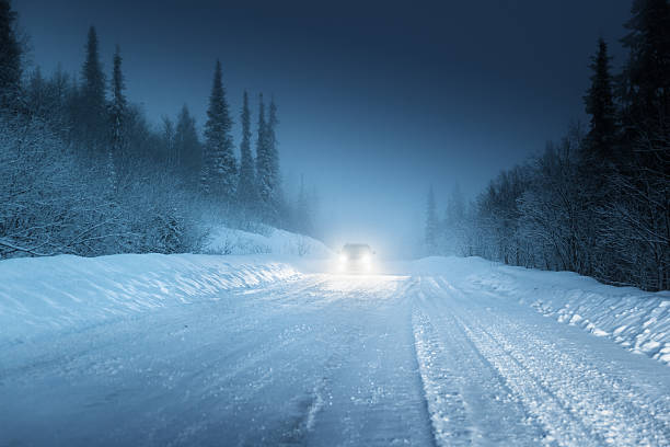 istock Car lights in winter Russian forest 506670249