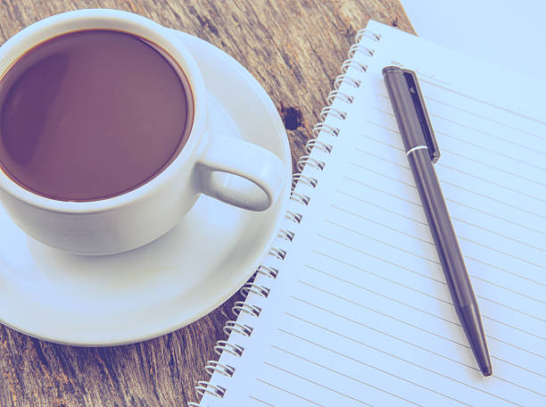 istock Cup of coffee, note, on wooden table 506671215