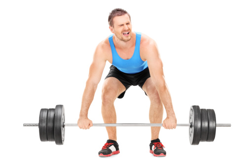 Bodybuilder struggling to lift a barbell isolated on white background