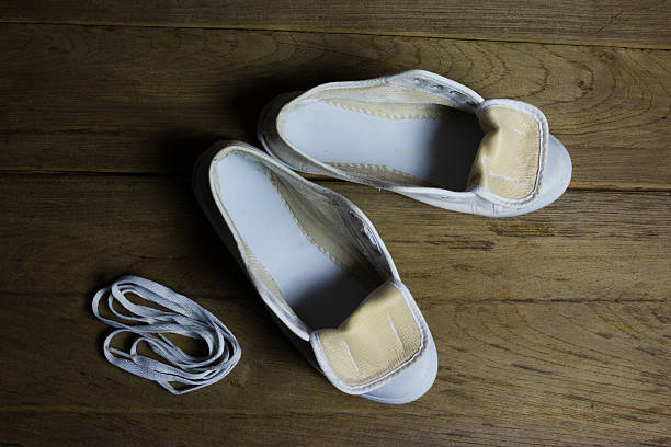 istock White canvas shoes on wood background, still life 506672186