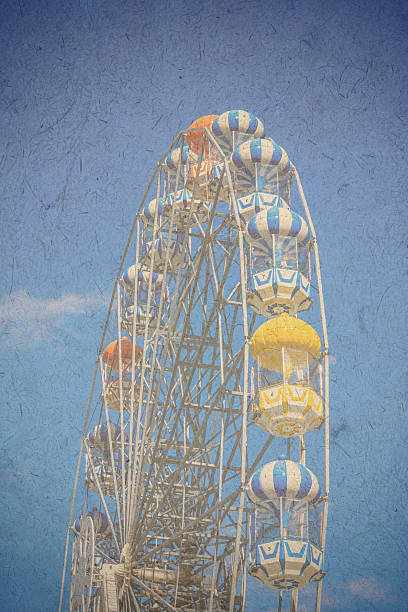 istock Vintage ferry wheel under bright blue sky 506673389