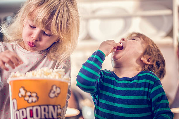 istock Cute Little Kids Eating Homemade Popcorn 506676032