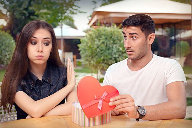 Girl Refusing Heart Shaped Gift From Her Boyfriend Materialist girlfriend refusing a present from her loved one gift for girlfriend stock pictures, royalty-free photos & images