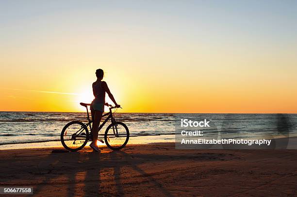 Catching A Moment In Time Sporty Woman Cyclist At Sunset Stock Photo - Download Image Now