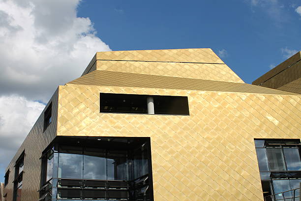 istock Modern building clad with gold-coloured metal scales 506688107