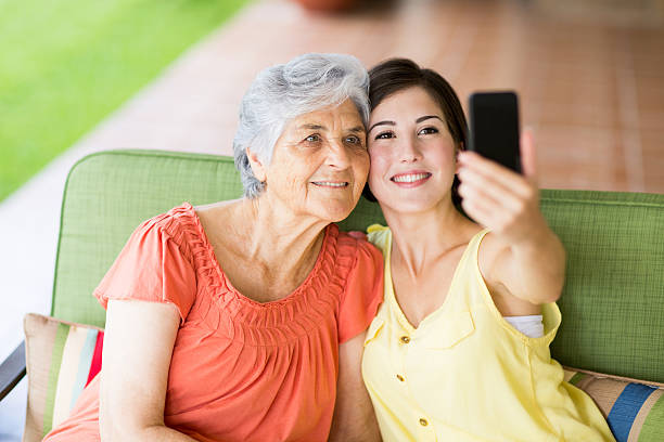istock Granddaughter taking picture with cellphone 506688367