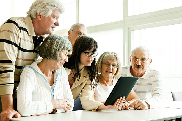 istock group of seniors at lecture examine tablet pc 506688559