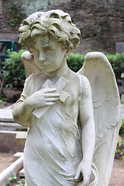 istock Angel statue with cross 506688737