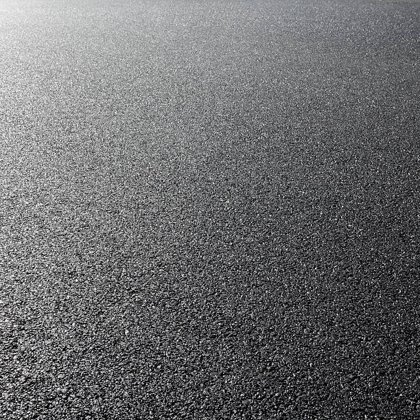 istock close-up horizontal view of new asphalt road 506689517